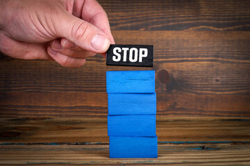 STOP. Business and development concepts. blue and black blocks on wood texture background