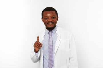 Happy black doctor man with small beard in white coat bright shirt got idea isolated on white...