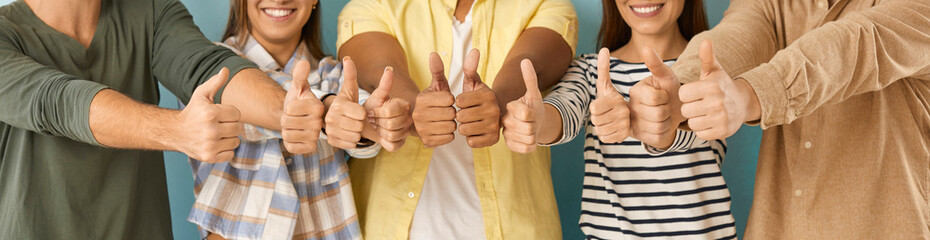 Diverse group of happy cheerful young people showing thumbs up. Joyful optimistic multiethnic multicultural girls and guys doing like gestures all together. Human hands, close up, cropped shot, banner - obrazy, fototapety, plakaty
