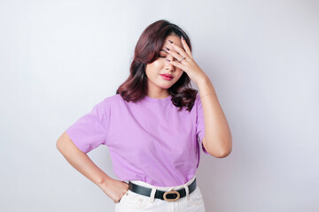 Portrait of young Asian woman isolated by white background feeling frustrated with helpless face...