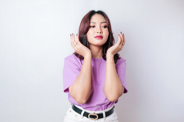 Portrait of young Asian woman isolated by white background feeling frustrated with helpless face...