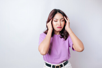 Portrait of young Asian woman isolated by white background feeling frustrated with helpless face expression.