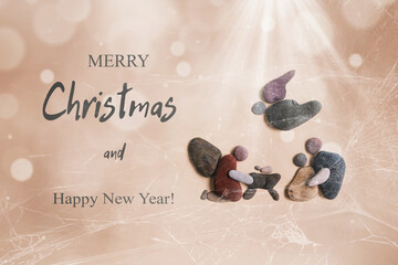 Merry Christmas. Festive Christmas card with the birth of Jesus made of stones...