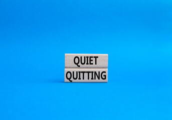 Quiet quitting symbol. Concept word Quiet quitting on wooden blocks. Beautiful blue background....