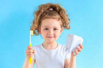 girl holding tooth dent and toothbrush. Kid training oral hygiene. creative medical dental dentistry sromatology. Child learning brushing, cleaning teeth. Prevention of caries. dental care kids