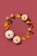 Fototapeta na wymiar Autumn flat lay wreath of pumpkin, leaves and flowers with berries top view. Vertical format with copy space