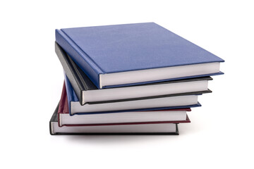 Stacked hardcover notebooks on white background. Education business concept.