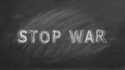 Lettering STOP WAR hand drawn in chalk on a school blackboard.