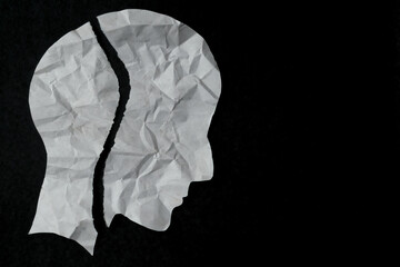 Torn paper in the shape of a person's head. mental health issues, Anxiety, depression, broken mood...