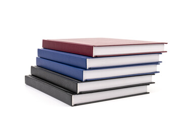 Stacked hardcover notebooks on white background. Education business concept.