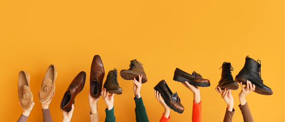 Many hands with different stylish shoes on orange background - obrazy, fototapety, plakaty