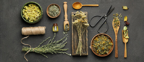 Composition with different dry herbs on dark background, top view