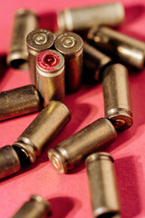 Casings and cartridges on red background.