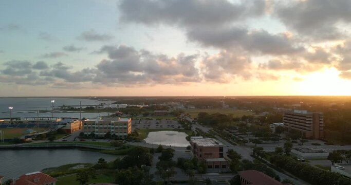 Drone shot over historic downtown Pensacola in Florida near Blue Wahoos stadium at sunset