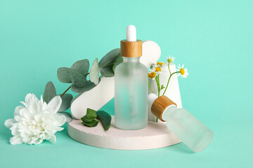Composition with bottles of essential oil and plaster decor on color background