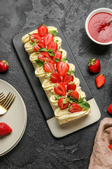 Plate with tasty strawberry roll cake, fresh berries and jam on dark background