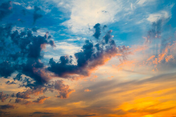 Beautiful black and yellow clouds in blue sunset sky