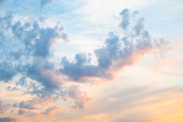 Beautiful pink and yellow clouds in the blue sunset sky