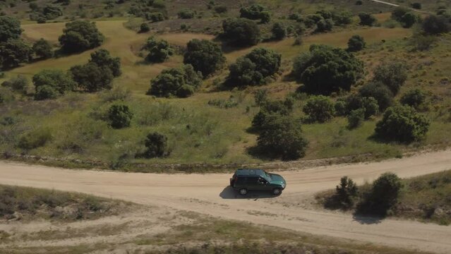 Aerial shot of a 4x4 vehicle turning left in a fork