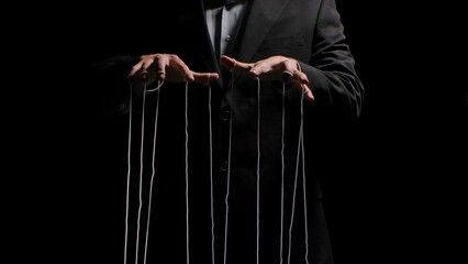 Man hands with strings on fingers on black background. Violence, harassment, bullying concept....
