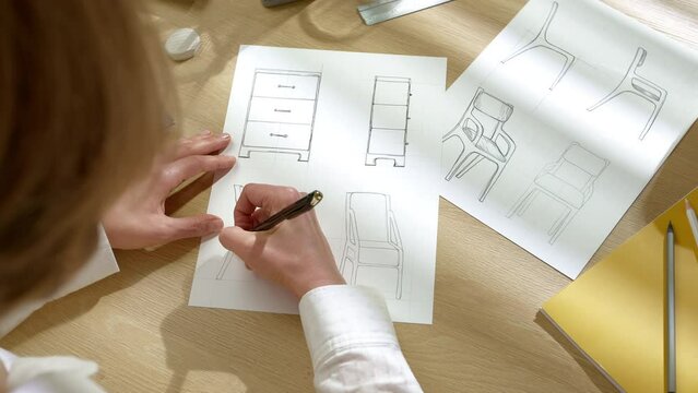 The designer draws sketches of furniture products on paper. The artist creates a prototype of chairs.
