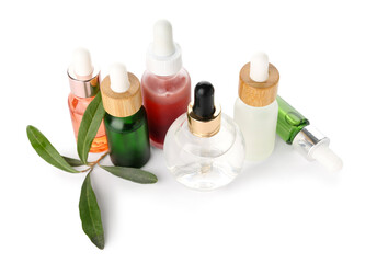 Different bottles with essential olive oil on white background