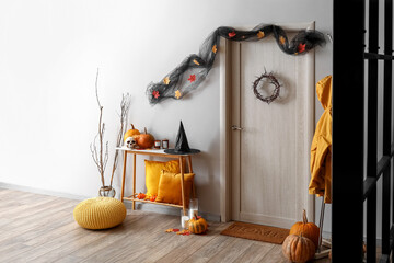 Interior of hall decorated for Halloween with table and rack