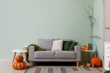 Fototapeta Interior of living room decorated for Halloween with sofa and tables obraz