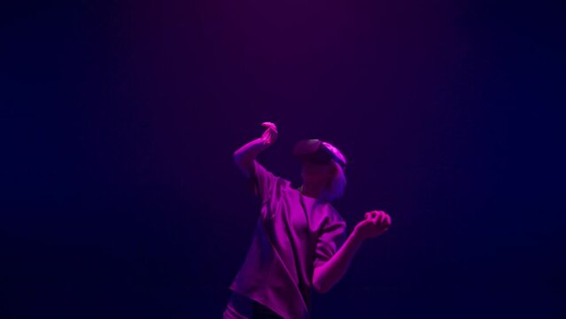 Virtual reality player dancing in neon lights closeup. Energetic man experience