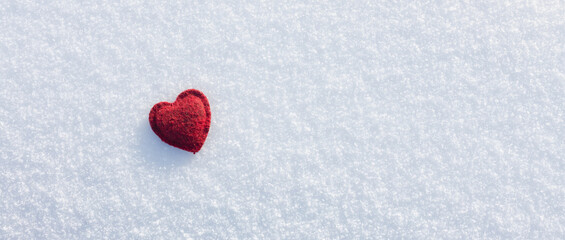  red single heart on a frosty white snow background. Love and St. Valentine day concept, free space for text
