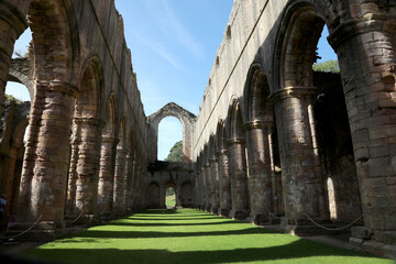 Interior of the ruined Fountains Abbey church looking down the nave, in North Yorkshire, England, UK.