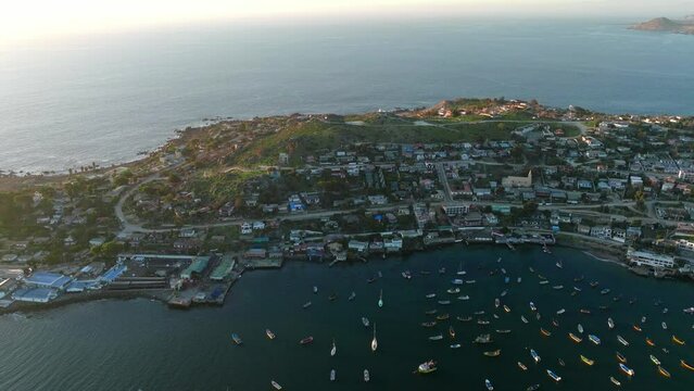 Aerial view dolly in of the Tongoy peninsula, Coquimbo region, Chile. Sunset time