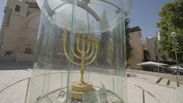 The Golden Menorah, a Jewish monument protected under bulletproof glass, at the Western Wall square in Jerusalem. Panning closeup shot.
