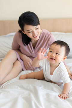 Young mother playing with baby