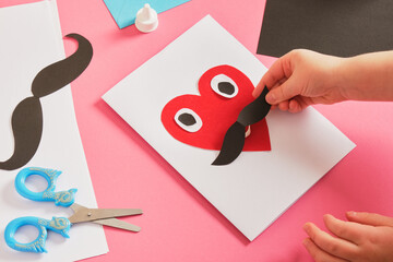 child makes a card for father's day, red paper heart with mustache, card for dad step by step instructions