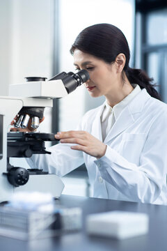 Scientist looking through a microscope
