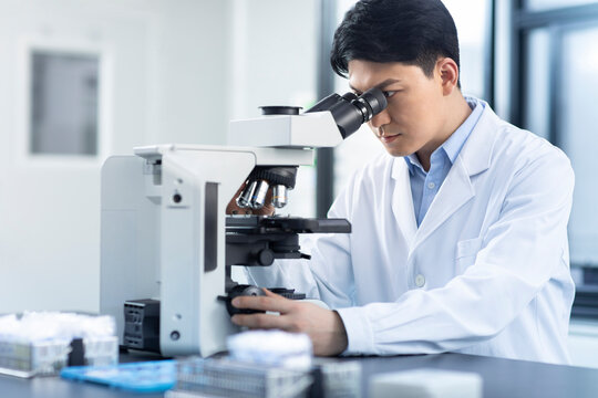 Scientist looking through a microscope