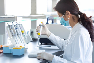 Scientist pipetting samples in laboratory