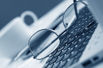 glasses on the laptop keyboard