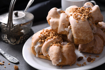 Close-up of delicious croissants with white poppy seeds, nuts and cup of coffee.
