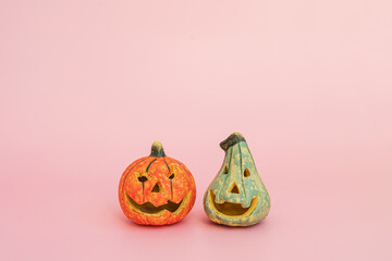 Colourful halloween pumpkins on pink background with copy space. Minimal autumn fall holidays concept