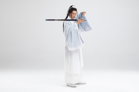 Young swordsman in ancient costume