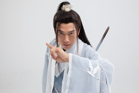 Young swordsman in ancient costume