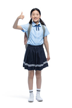 Cheerful schoolgirl doing thumbs up