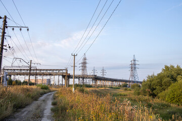 industrial landscape with heavy pollution produced by a large factory. Chemical plant. Pipes on the territory of the plant. power lines.