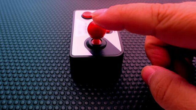 remote control on dark background, red button, finger presses red button, joystick control, threat of using nuclear, chemical weapons of mass destruction, concept Rocket launch at push of button