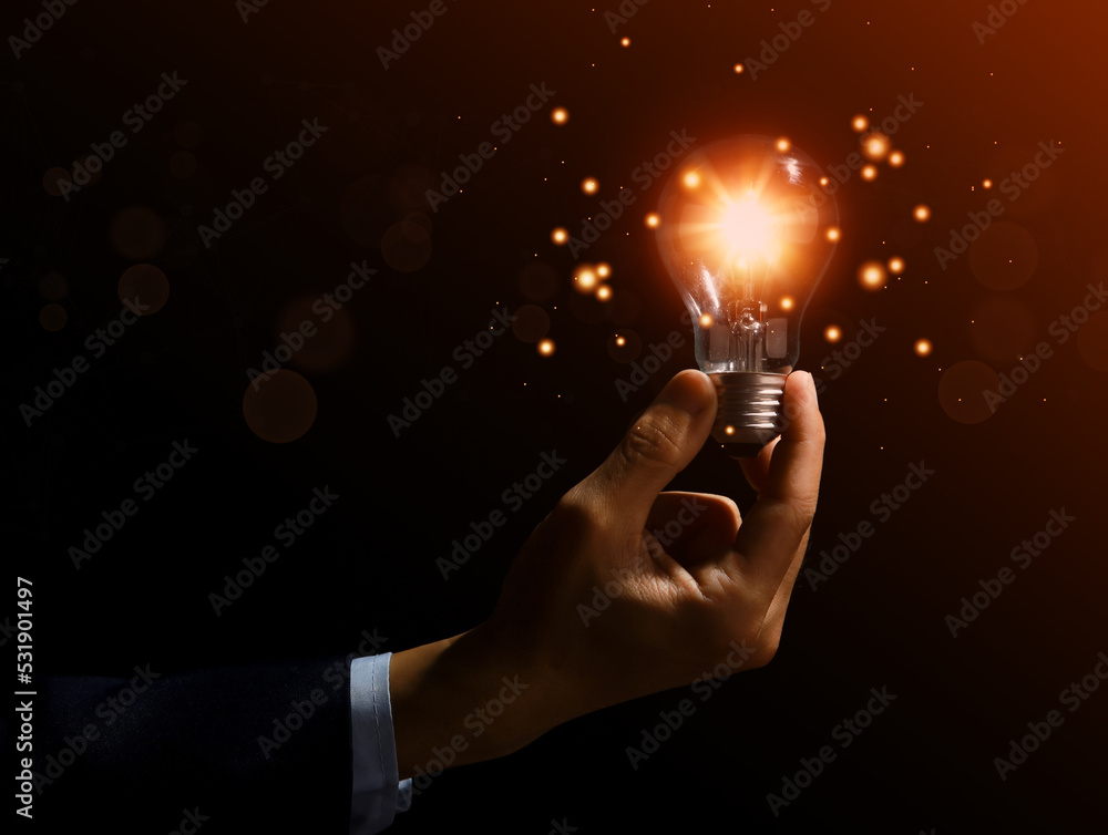 Wall mural businessman holding a light bulb graphic Digital technology abstract. idea Creative