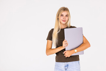 Full length portrait of a smiling businesswoman carrying laptop while standing isolated over white background