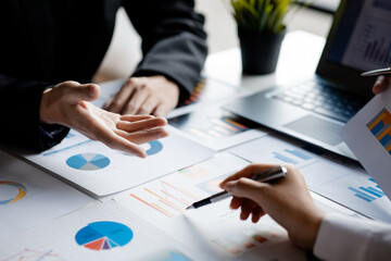 The sales department is having a monthly summary meeting to bring it to the department manager, they are verifying the correctness of the documents that are prepared before bringing in to the manager