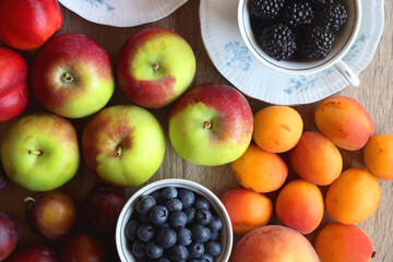 Various healthy seasonal food arranged on wooden background. Flat lay.